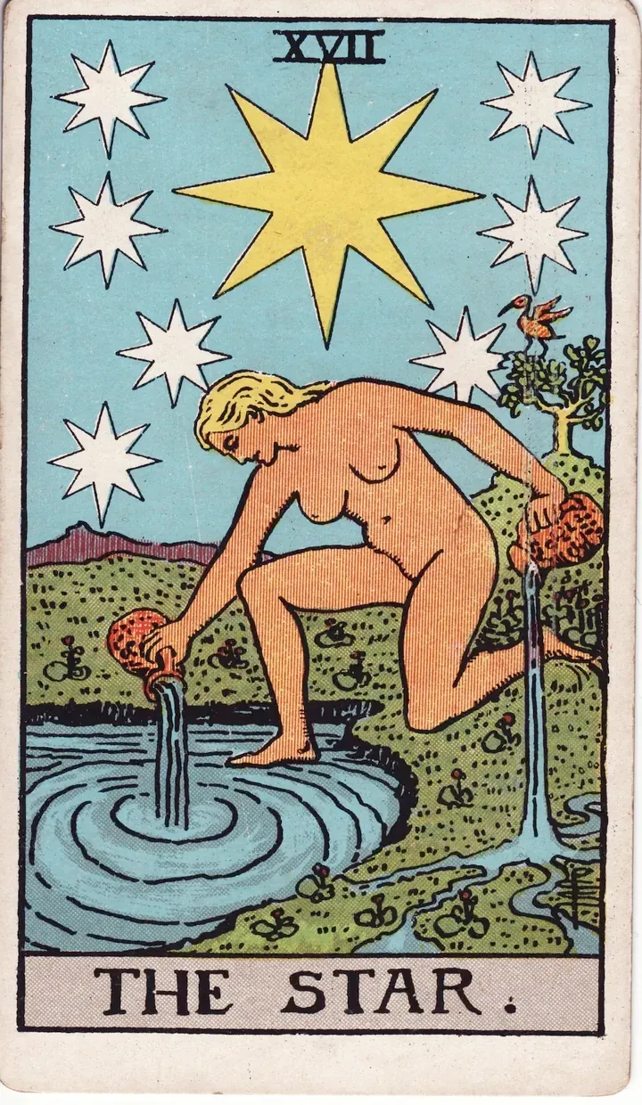 Vesper laying out a tarot spread by candlelight